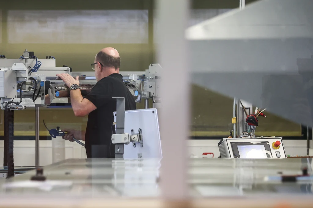 Factory worker in CIPEM's French facility operating advanced machinery